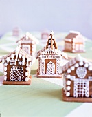 Close-up of gingerbreads in shape of houses decorated with cream on table