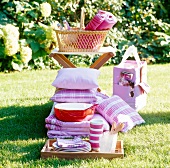 Picnic baskets with pillows and other picnic utilities in garden