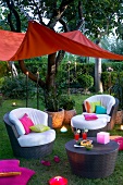 Sofa with cushions in colourful sitting area in garden for party