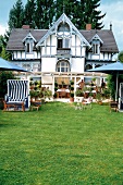 Exterior of Hotel Villa Barleben with garden and guests on porch