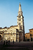 People walking in front of Romanesque cathedral, Modena, Italy