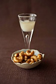 Caramelized cashews with chilled aperitif pastis drink
