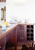 Close-up of dark brown wood kitchen with integrated wine rack