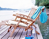 Two wooden loungers on waterfront