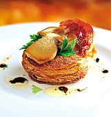 Close-up of potato tart with mushrooms on plate