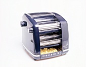 Close-up of noodle machine against white background