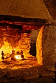 Large stone fireplace with burning fire
