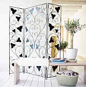 Transparent screen room divider with wrought iron leaf decor