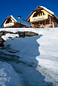 Alpine huts covered with snow in winter