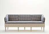 Blue and white plaid sofa with white legs against white background