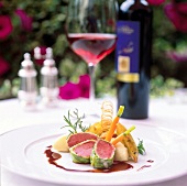 Venison wrapped in savoy with celery puree and elderberry sauce on plate