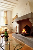 Fire place with red wine on glass table in living room