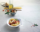 Spaghetti in bowl with ingredients on white background