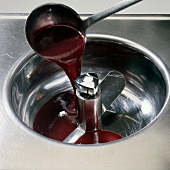 Close-up of fruit syrup being poured in stirrer