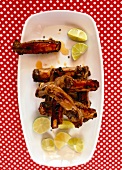 Pork ribs limonen with lemon slices on serving plate, overhead view