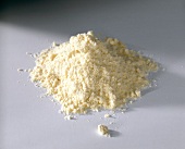 Close-up of corn flour heap on white background