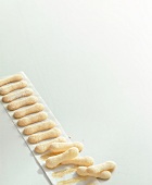 Ladyfinger cookies on baking paper, copy space