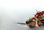 Tomato sauce in pan and fresh tomatoes with basil on white background, copy space