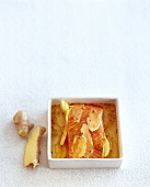 Sliced marinade ginger for salmon in serving dish on white background