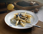 Potato noodles with poppy seeds on plate with fork