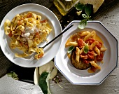 Pappardelle with vegetables and penne with tomato and eggplant on plates