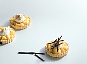 Quince tart with rolled chocolate and cream on white background