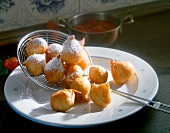 Dutch donuts with steel wire strainer on plate