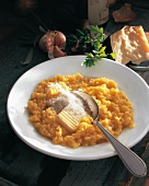 Risotto alla milanese with butter and cheese on plate