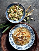 Noodles with chicken and asparagus with fried noodles on two plates