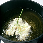 Close-up of elderflower being fried in boiling water