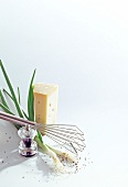 Cheese, green onions and pepper mill on white background