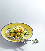 Plate of lemon pasta with asparagus on white background