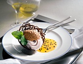 Chocolate mousse and chocolate lattice with passion fruit sauce on plate