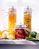 Preserved pickled made of citrus fruits in glass jars with metal lids on table