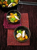 Vegetable chicken soup with seasoned sour cream in bowls