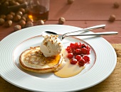 Pancakes with maple syrup and hazelnut ice cream on plate