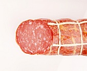 Close-up of old German ham sausage on white background