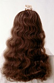 Rear view of brunette woman with artificial curly long hair