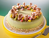 Easter cake with pineapple, marzipan bunnies and eggs on plate