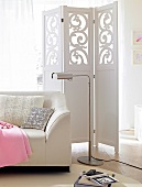 White leather sofa, reading lamp and dressing partition in living room