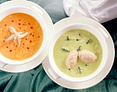 Close-up of bowls with cauliflower-broccoli soup and carrots-pepper cream soup