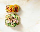 Close-up of bread with shrimp, onion, cucumber and crisp bread with ham and mandarin