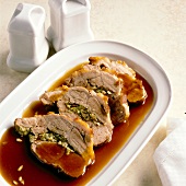 Stuffed roast pork with sauce on plate