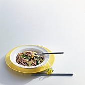 Plate of soba noodles with Chinese cabbage on white background 
