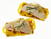 Close-up of crisp bread with aspic and yellow bell pepper