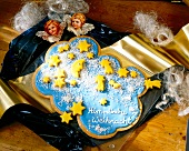 Cloud shaped giant cookie topped with small star shaped cookies