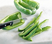 Close-up of green pepper cut lengthwise into thin strips
