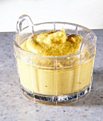 Close-up of yellow dijon mustard in glass bowl