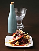 Pear slices and beetroot carpaccio with mushrooms on plate
