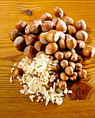 Close-up of large and small hazelnuts, chopped almonds